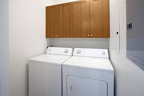 One and Two Bedroom Laundry Room with wall cabinets above side by side Washer and Dryer One and Two Bedroom Laundry Room with wall cabinets above side by side Washer and Dryer  at Polo Villas, Bakersfield, 93312